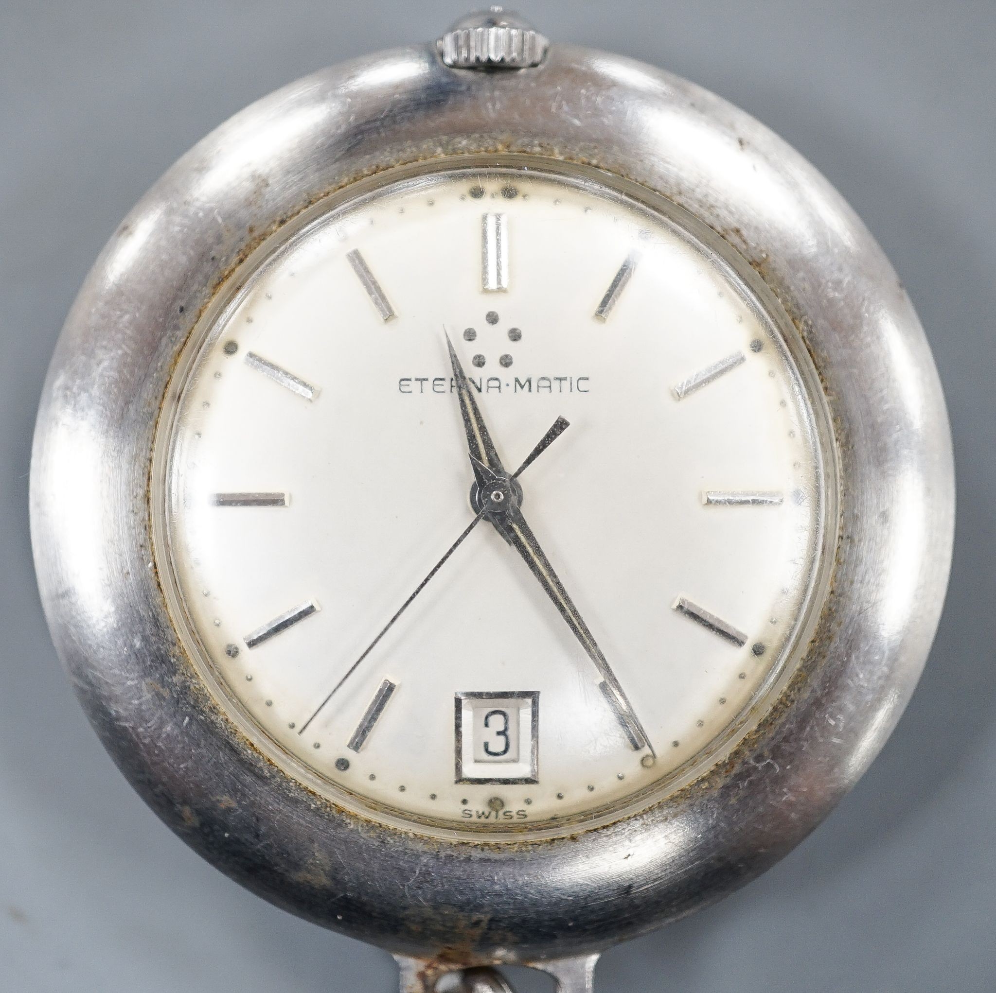 A base metal cased Eterna-matic manual wind dress pocket watch, with date aperture, on a metal chain.